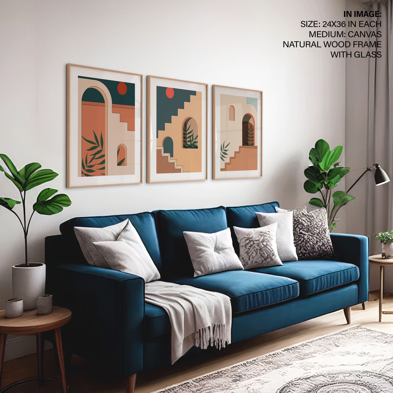Three arched architectural prints hung in a tight row above a blue sofa, spaced to read as a single block