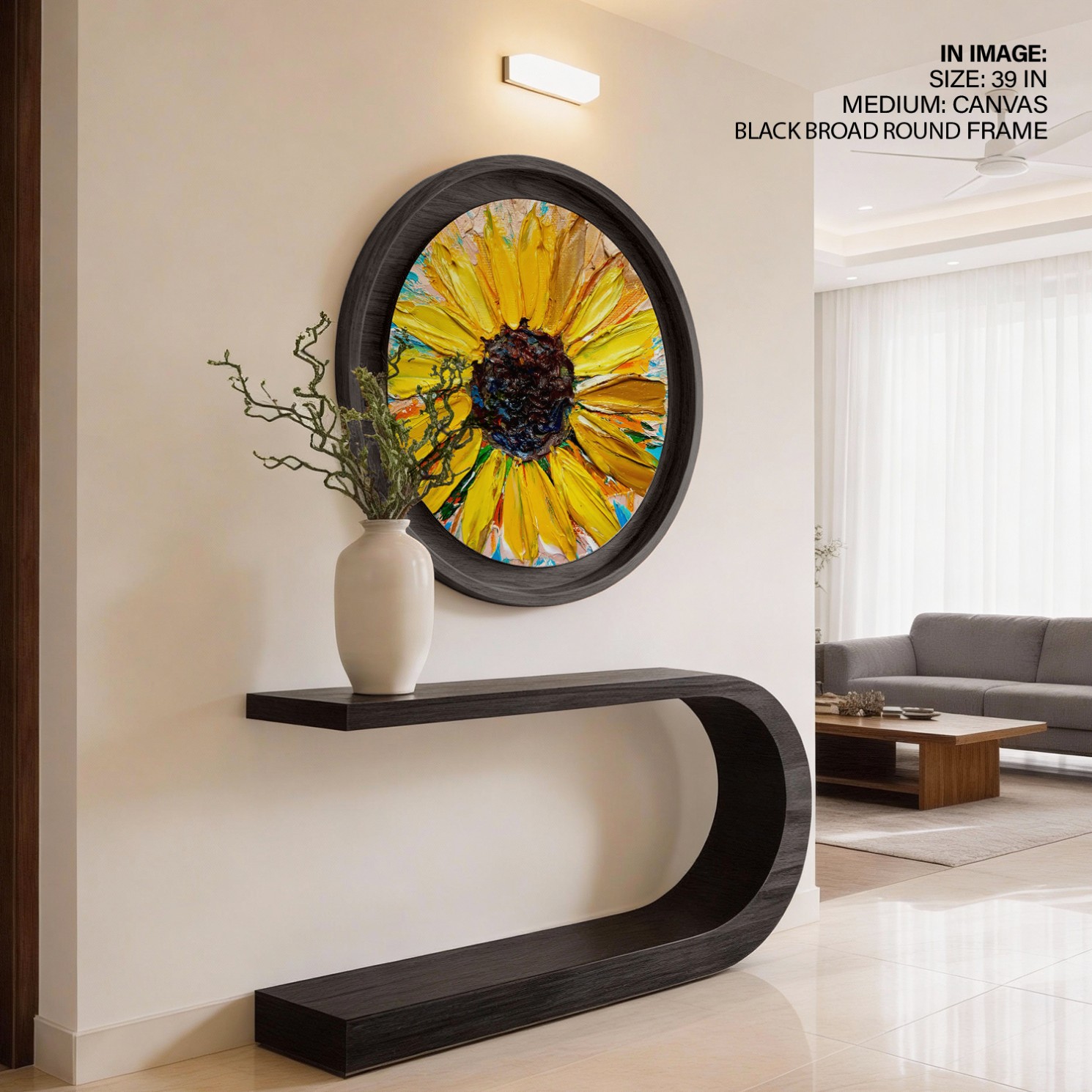 A bold circular sunflower artwork above a curved black console in an entrance hall